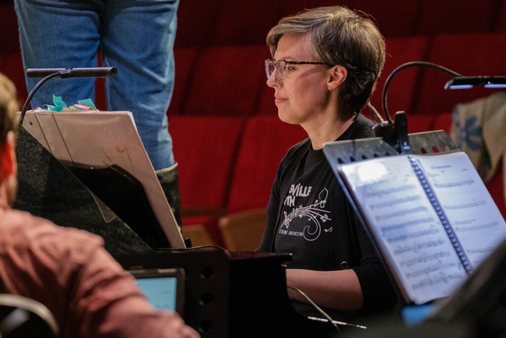 Piper:A New Musical composer Avril Callicutt sits at piano viewing a musical score